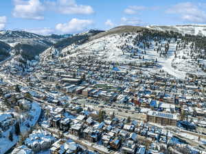 Snowy aerial view featuring a mountain view