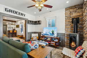 Living room with ceiling fan and light hardwood / wood-style floors