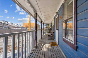 Snow covered deck featuring a mountain view