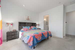 Carpeted bedroom with ensuite bathroom