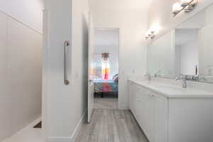 Bathroom with hardwood / wood-style flooring and vanity