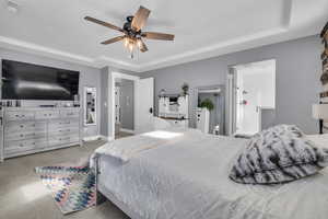 Bedroom featuring a raised ceiling and ceiling fan