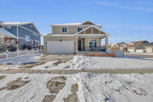 View of front of home featuring a garage and covered porch