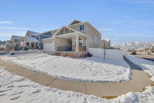 View of front of house featuring a garage and a mountain view