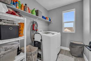 Washroom featuring separate washer and dryer and light wood-type flooring