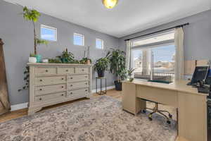 Home office with light hardwood / wood-style flooring