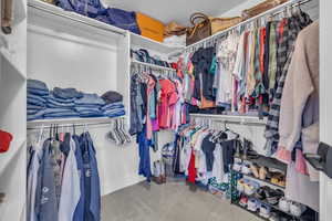 Walk in closet with carpet flooring