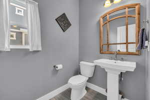 Bathroom with toilet and hardwood / wood-style floors