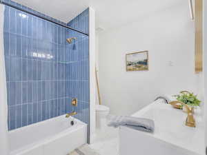 Full bathroom featuring a double vanity, shower / bath combo