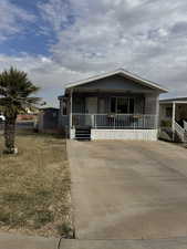 View of front of home featuring a porch and a front lawn