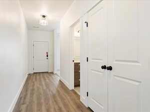 Corridor featuring light hardwood / wood-style flooring