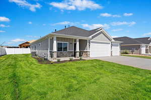 View of front of property featuring a garage, central AC, and a front yard