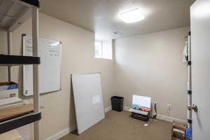 Interior space with a textured ceiling and light carpet