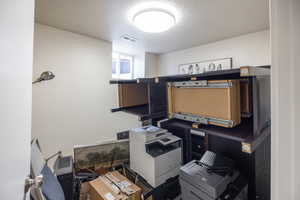 Office area featuring a textured ceiling