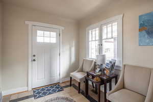 Entrance foyer featuring light tile patterned flooring