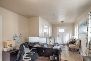 Office space with light tile patterned floors and a textured ceiling