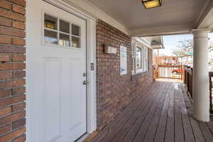 Doorway to property featuring a porch