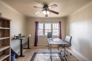 Tiled office with ceiling fan and a textured ceiling