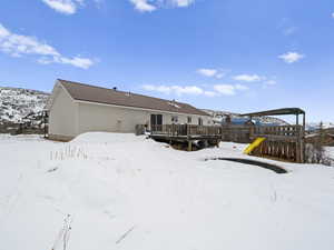 Large yard with playground and a trex deck