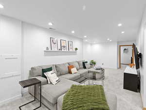 Living room featuring plenty of light and light colored carpet