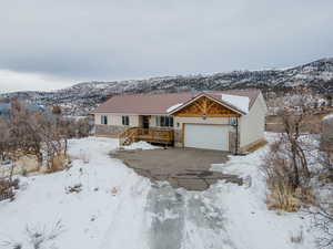 View of front facade with a garage and a mountain view