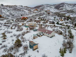 Snowy aerial view featuring a mountain view