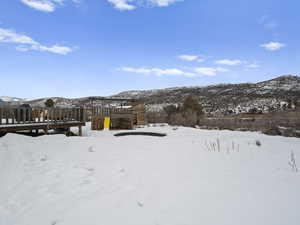 Large yard backyard view. In ground trampoline and large play house. The snow will melt soon enough.