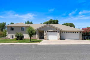 View of front of home featuring a garage and a front lawn