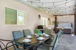 View of patio / terrace with a grill and a hot tub