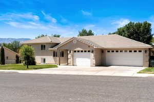 View of front of home featuring a mountain view and a garage