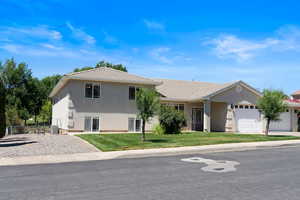 View of front of home featuring a garage and a front yard