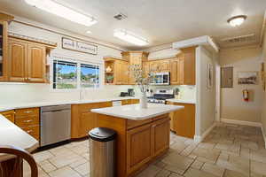 Kitchen featuring sink, stainless steel appliances, electric panel, and a kitchen island