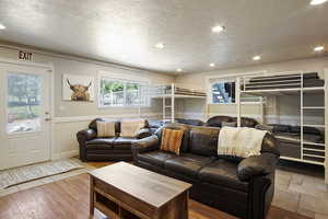 Living room featuring tile patterned floors and a textured ceiling