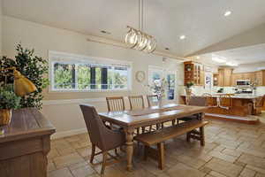 Dining area with french doors and lofted ceiling