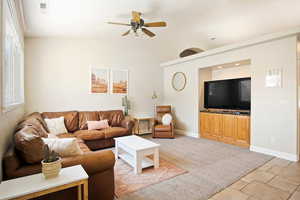 Living room with light carpet and ceiling fan