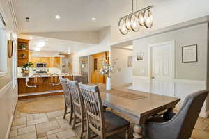 Dining space featuring vaulted ceiling