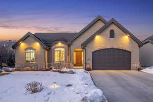 French country inspired facade with a garage