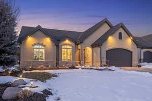 French country inspired facade featuring a garage