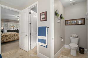 Bathroom with ceiling fan and toilet