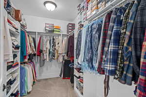 Spacious closet with light colored carpet