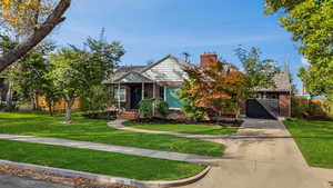 View of front of property featuring a garage and a front yard