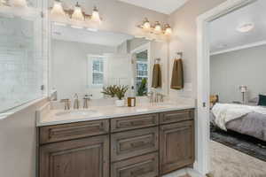 Bathroom featuring ornamental molding and vanity