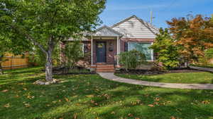 Bungalow-style house featuring a front lawn