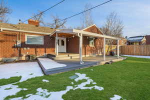 Rear view of house with a yard