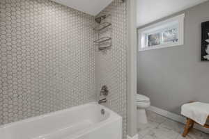 Bathroom with shower / tub combination and toilet