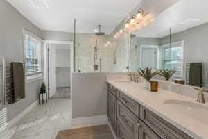 Bathroom featuring vanity and a tile shower