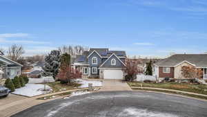 Front of property featuring a garage and solar panels