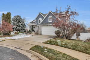 View of front of property featuring a garage and a front yard