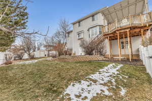 View of yard featuring a wooden deck and a shed