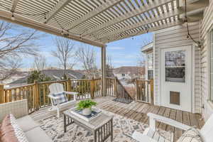 Wooden terrace featuring a pergola and outdoor lounge area